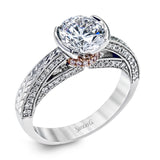 This exquisite white gold engagement ring is highlighted by .04 ctw of princess cut white diamonds and .34 ctw of round cut white diamonds.