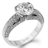 This exquisite white gold engagement ring is highlighted by .04 ctw of princess cut white diamonds and .34 ctw of round cut white diamonds.
